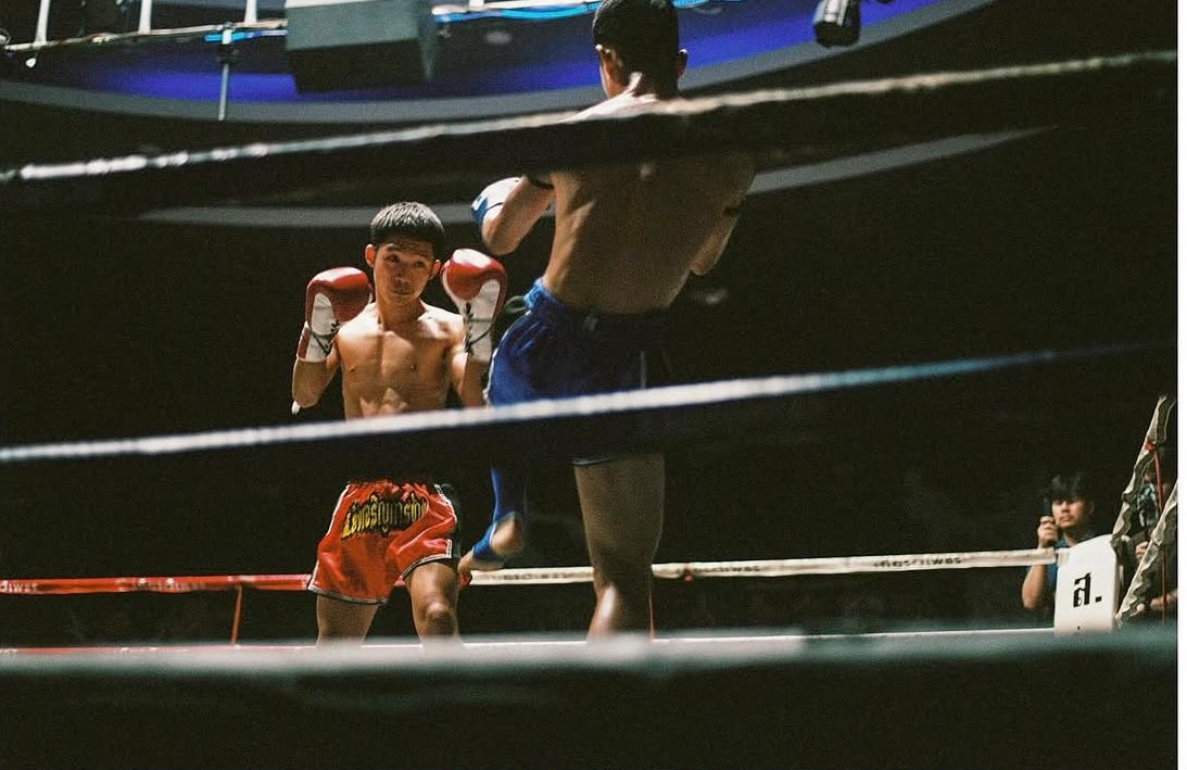 A trainer tending to a fighter in the corner